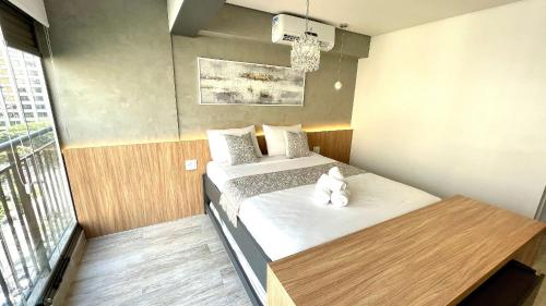 a small room with a bed with a stuffed animal on it at Haus Stay . Luxo . Vitralli Moema in Sao Paulo