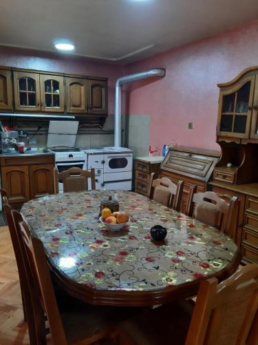 a kitchen with a table with a bowl of fruit on it at Vila Mir in Pirot