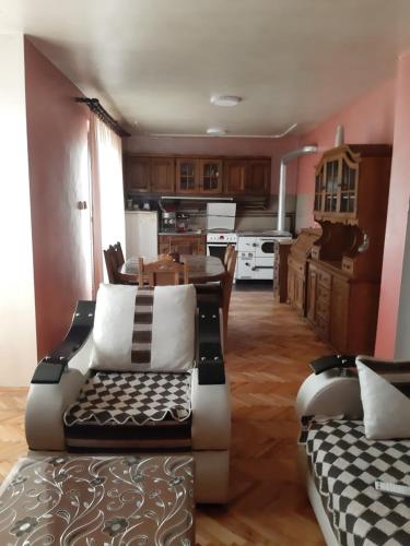 a kitchen and living room with a couch and a table at Vila Mir in Pirot