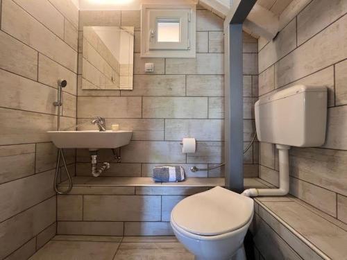 a bathroom with a toilet and a sink at Villa Perivoli in Parga