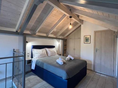 a bedroom with a bed with two teddy bears on it at Villa Perivoli in Parga