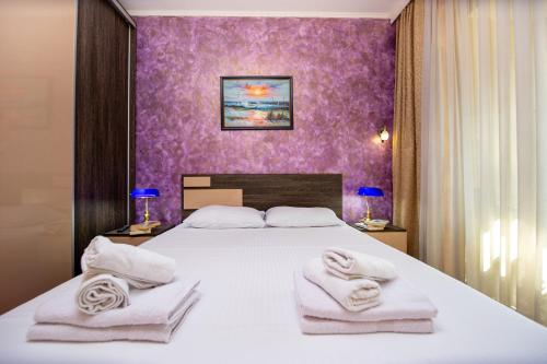 Postel nebo postele na pokoji v ubytování SunSea Apartments