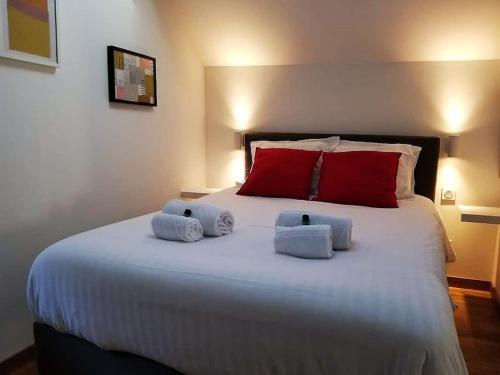 a bedroom with a large bed with towels on it at La Mansarde : Cosy et Charme au Centre Historique in Dijon