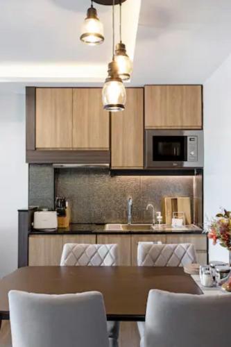 a kitchen with a table with chairs and a microwave at Reiz - Private Residence in Chiang Mai