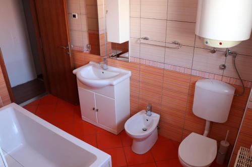 a bathroom with a toilet and a sink at Nona Lili apartment in Izola
