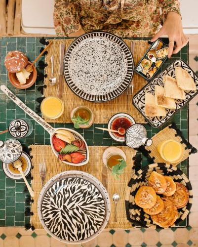 a table topped with plates and bowls of food at Art riad mazighen in El Jadida