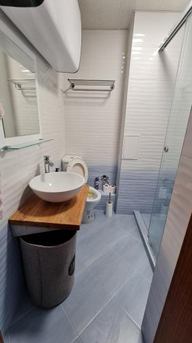 a bathroom with a sink and a shower and a toilet at Magic Sea View in Tsarevo