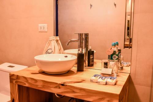 a bathroom counter with a sink and a mirror at Cooper Hotel Boutique in Cusco