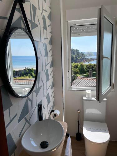 a bathroom with a sink and a mirror at Hotel Playa de Sardiñeiro in Finisterre