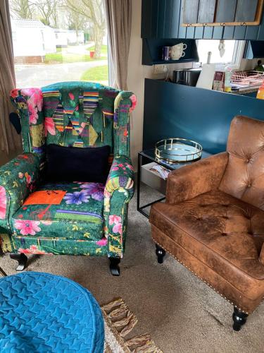 a living room with a couch and a chair at Serendipity in Sutton on the Forest