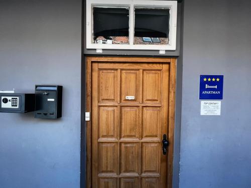 a wooden door with a window above it at Apartments Top Center in Zagreb