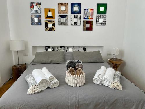 a bed with a bunch of towels on it at Bijoux Luxury Apartment in Old Town in Bari