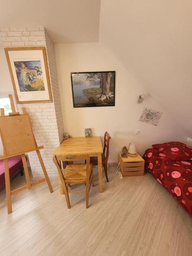 a room with a table and a bed and a desk at KER YODA in Binic-Etables-sur-Mer