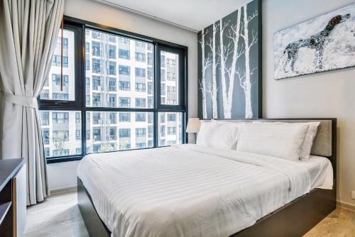 パタヤ・セントラルにあるThe Base Central Pattayaのベッドと大きな窓のある寝室