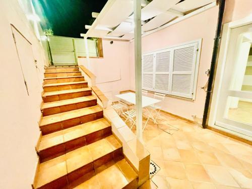 a staircase in a room with a table and a window at Maison Del Conero - Ombrellone e Lettini in Spiaggia Inclusi in Numana