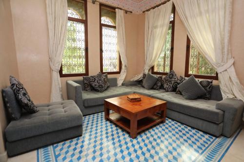 a living room with two couches and a coffee table at Equi Palace & SPA Near Aeroport in Berrechid