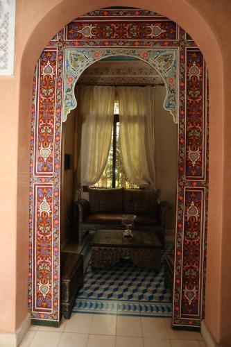 an archway with a couch in front of a window at Equi Palace & SPA Near Aeroport in Berrechid