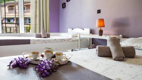 a bedroom with two beds and a table with flowers on it at Lovely Traditional House in Petrití