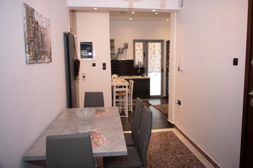 a kitchen and dining room with a table and chairs at Sophia’s place in Piraeus