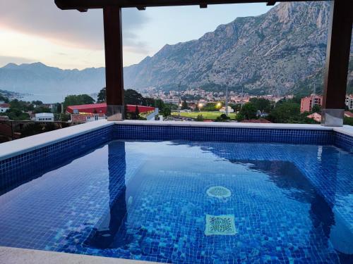 a swimming pool with a view of a mountain at Villa Vista Real in Kotor