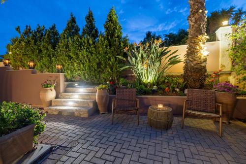 a patio with chairs and plants and a staircase at Olea Suites in Gouves