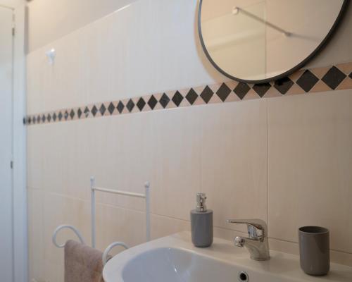 a bathroom with a sink and a mirror on the wall at PODERE IL QUADRO in Lamporecchio