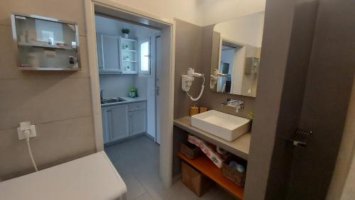 a small bathroom with a sink and a mirror at Niso in Livadion