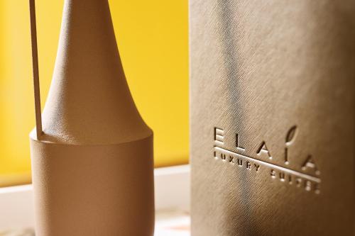 a close up of a brown vase next to a bottle at Elaia Luxury Suites Mykonos in Mýkonos City
