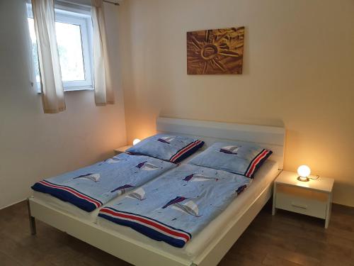 a bed with blue sheets and pillows in a bedroom at Villa Seeschwalbe Plau in Plau am See