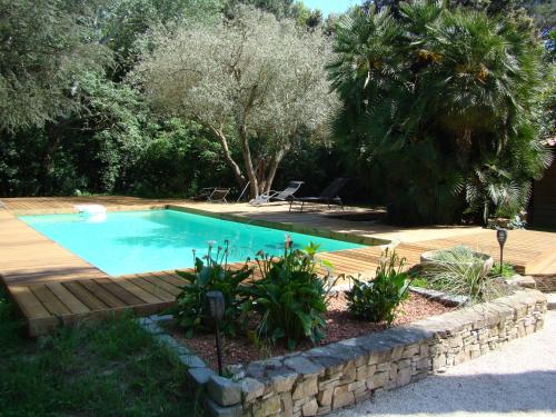 - une piscine dans une cour avec une terrasse en bois dans l'établissement La Villa Saint André - Argeles sur mer, à Argelès-sur-Mer