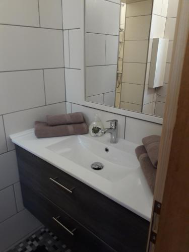 a bathroom with a sink and a mirror at Ferienwohnung Karin Humer in Bad Ischl