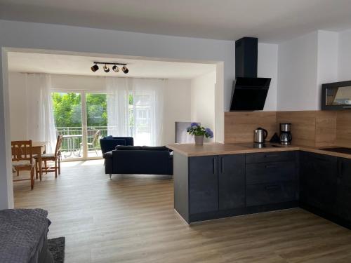 a kitchen and living room with a couch and a table at Weinquartier Kröv in Kröv