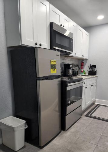 a kitchen with a refrigerator and a microwave at STUDIO 4A in Lakeland