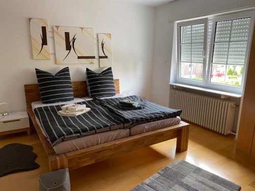 a bedroom with a bed with black and white pillows at Haus im Sternweg in Voerde