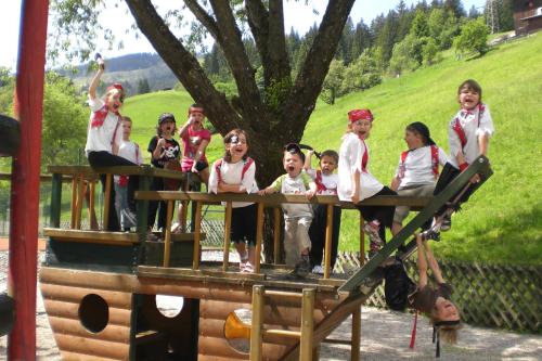 a group of children sitting on top of a roller coaster at Familienhotel Christoph in Ellmau