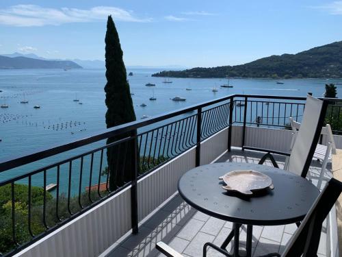 balcón con mesa y vistas al agua en La terrazza sul Golfo, en Portovenere