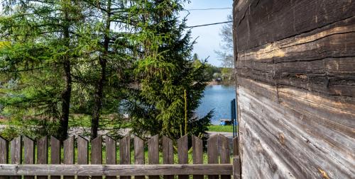 a wooden fence with a view of a river at Sielska Przystań in Sucha Rzeczka
