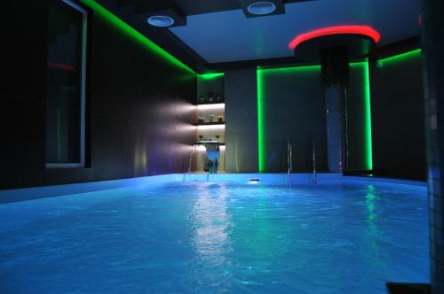 a room with a pool with green and green lights at Hotel Moskva in Banja Luka