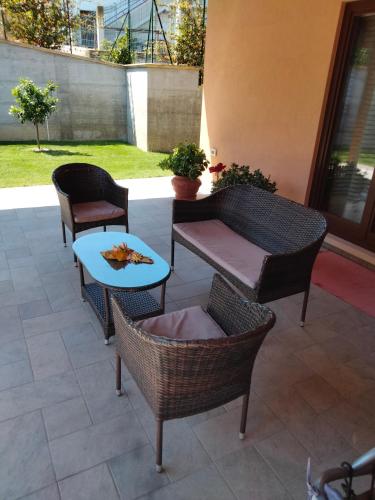 a patio with chairs and a table and a table at B&B La Casa di Giuliana in Cermignano