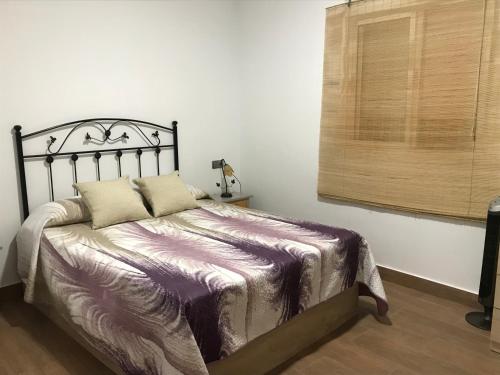 a bedroom with a bed with a metal head board at La Belleza de Rodalquilar in Rodalquilar