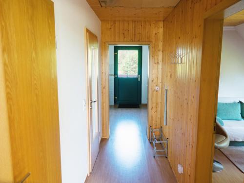 a hallway with a green door and wooden walls at Ferienwohnung Rohlffs Stolpe auf Usedom in Stolpe auf Usedom