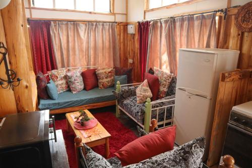 a living room with a couch and a refrigerator at Lemon Valley Farm in Elmenteita