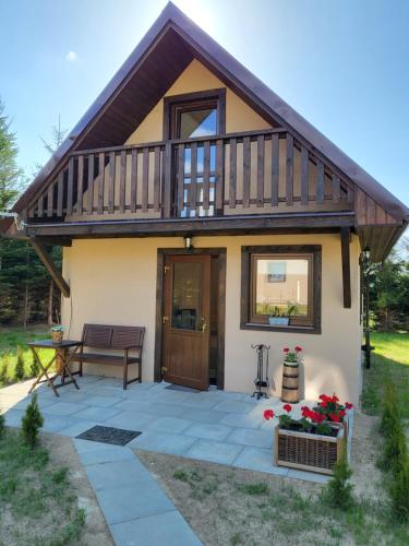 a house with a deck and a patio at Świerkowy Zakatek in Idzików