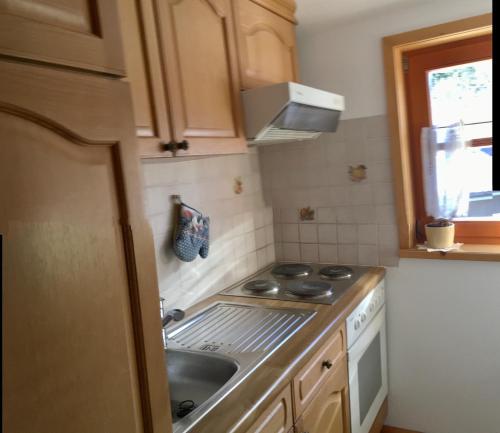 a small kitchen with a stove and a sink at Bio-Bauernhof Anawander in Mariahof