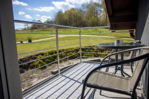 a balcony with a table and chairs and a view of a field at Apartmani San Martin in Sveti Martin na Muri