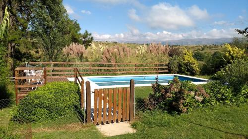 a fence around a swimming pool in a yard at LA LINDA - Cabaña de Montaña in Villa Berna