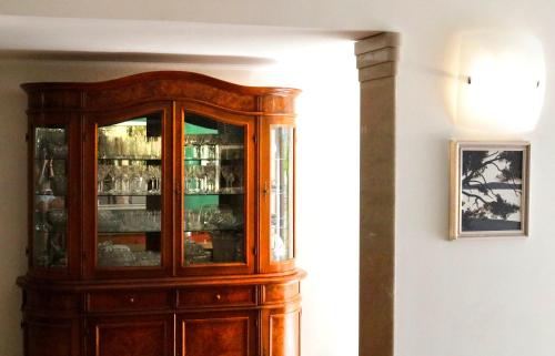 a wooden cabinet with glass doors in a room at Luxury Spalato Garden in Split
