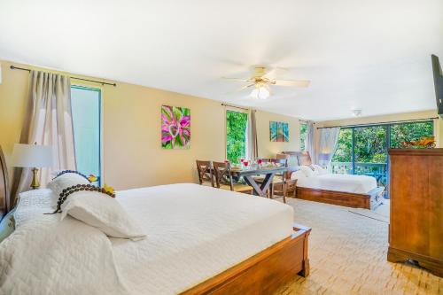 a bedroom with a bed and a dining room at Hale Moi #103A in Princeville