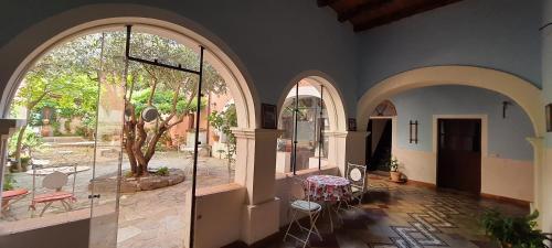 a room with arched windows and a table and chairs at Casa Camboni-Dimora Storica Bed & Breakfast in San Vito