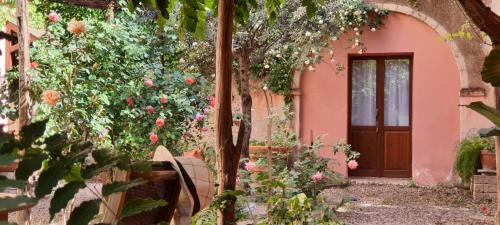a pink house with a door and some flowers at Casa Camboni-Dimora Storica Bed & Breakfast in San Vito